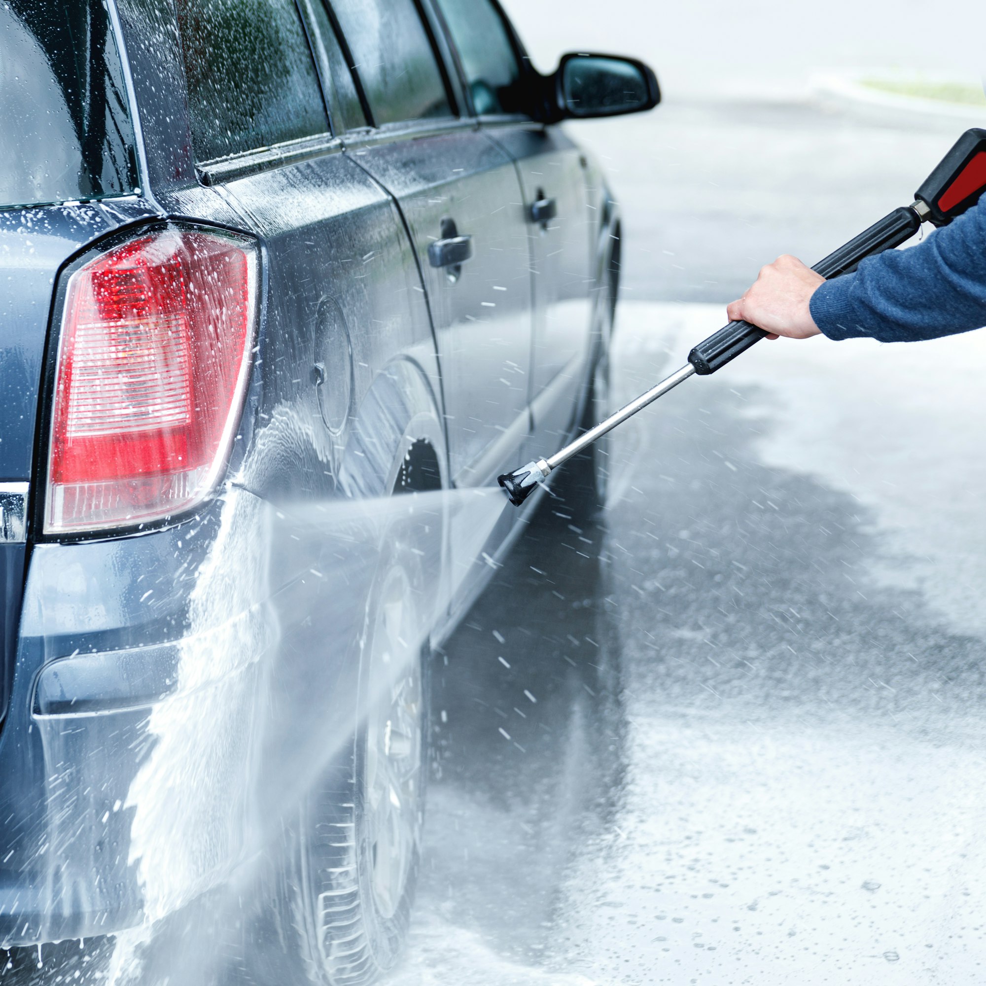 Car wash worker is washing client's car